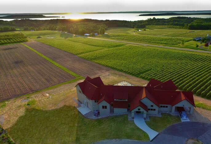 Guests relaxing with wine overlooking vineyards on Old Mission Peninsula